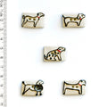 Off-white buttons with dog illustrations on a white background, accompanied by a ruler for scale.