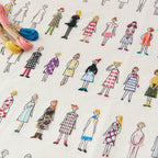 Close up of embroidered people in colorful dresses with on a white background