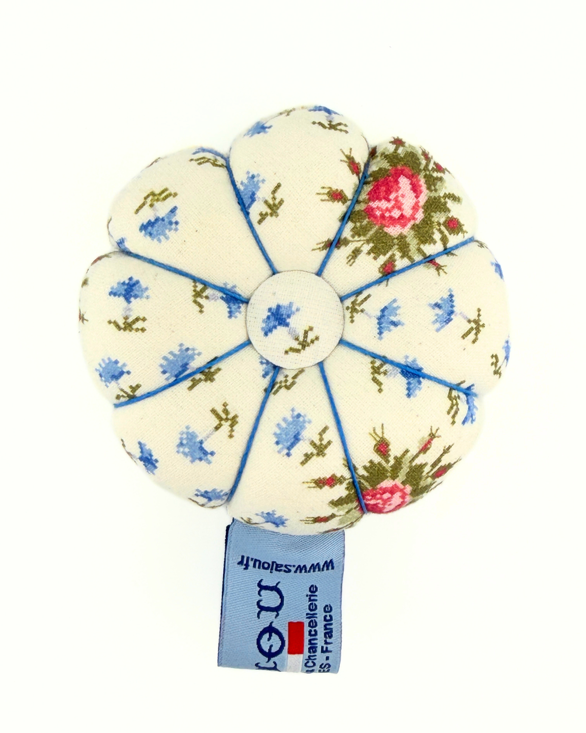 Floral-patterned pincushion on a white background