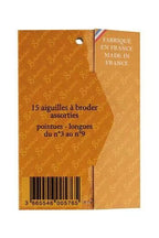 Back of packaging of sewing needles with text on a white background
