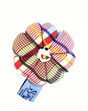 Colorful plaid push pin on a white background