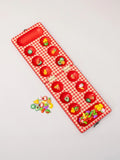 Red checkered board with colorful game pieces on a light gray background