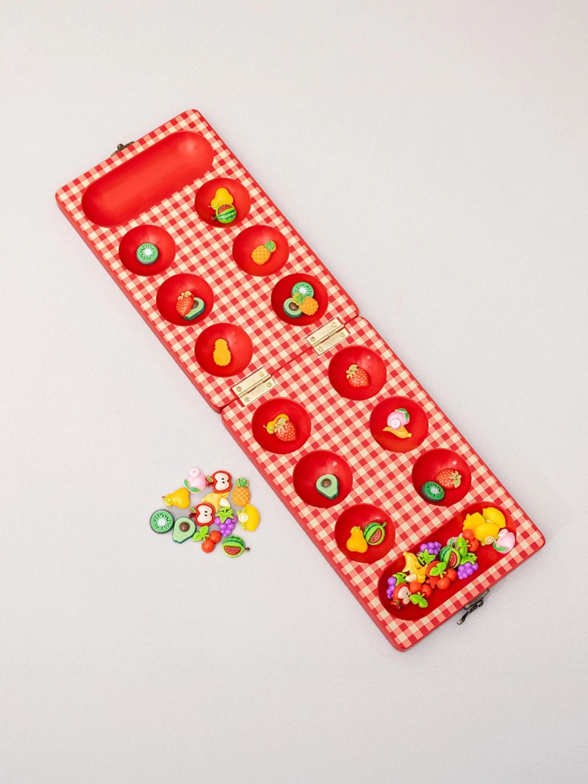 Red checkered board with colorful game pieces on a light gray background