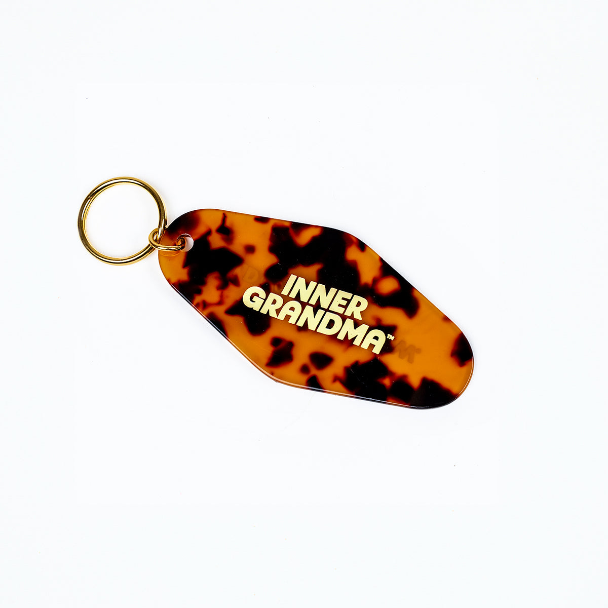 Tortoiseshell keychain with 'INNER GRANDMA' text on a white background