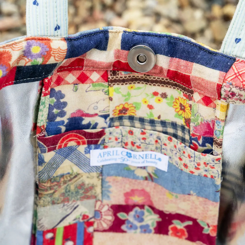 Colorful patchwork fabric with a visible brand label on a textured background