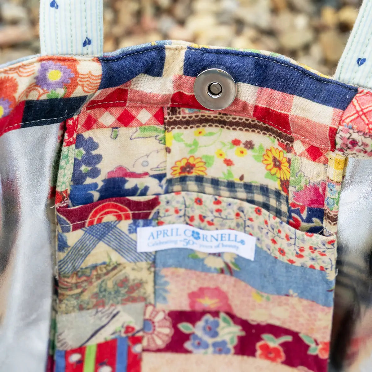 Colorful patchwork fabric with a visible brand label on a textured background