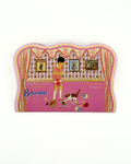 Decorative needle case with a design of a woman and dog, featuring the brand 'Sajou'.