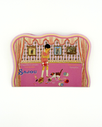 Decorative needle case with a design of a woman and dog, featuring the brand 'Sajou'.