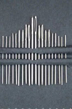 Up close of 20 needle set on a black background