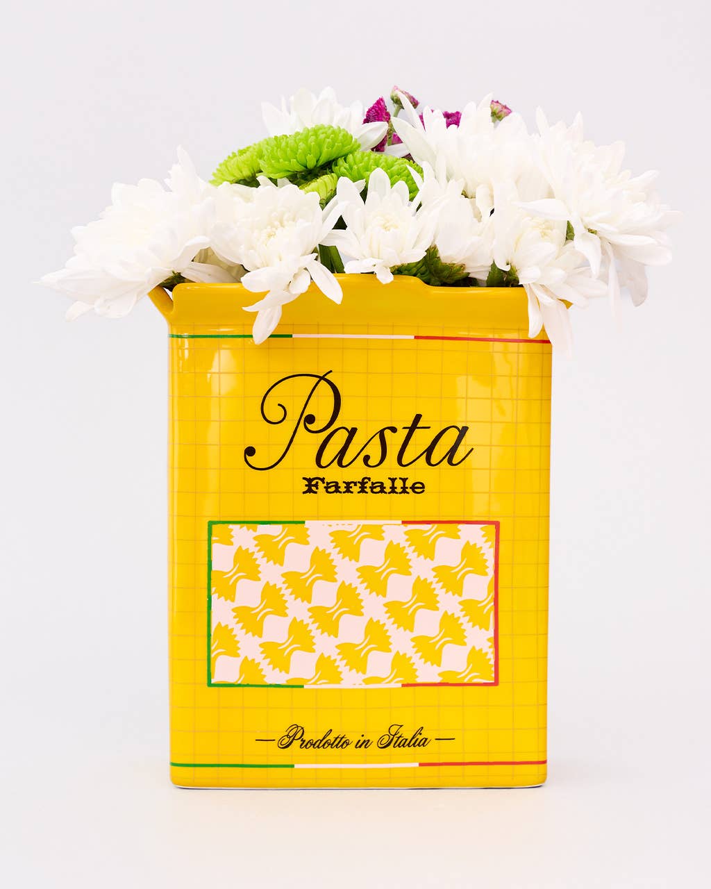 Yellow "pasta" vase with flowers on a white background