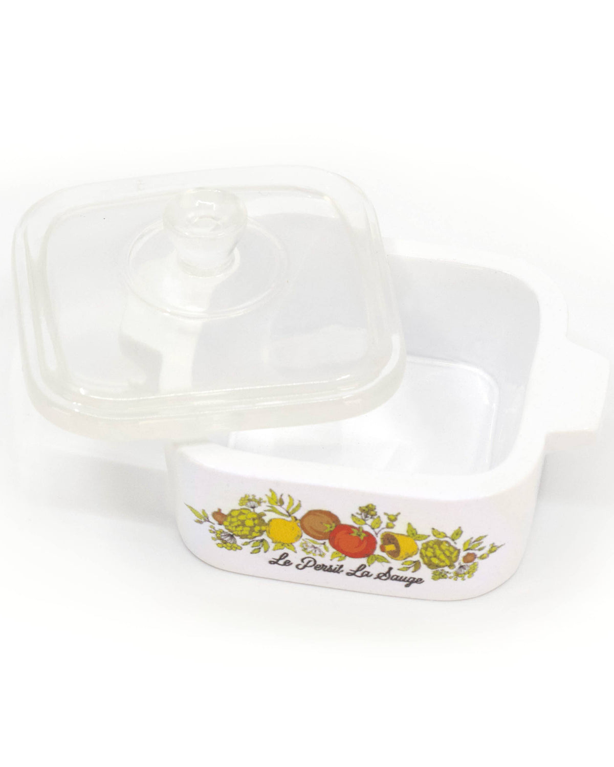 A white glass dish inspired trinket box with a clear plastic lid, featuring a colorful fruit border design and the text 'Le Départ Le Retour' on the front.