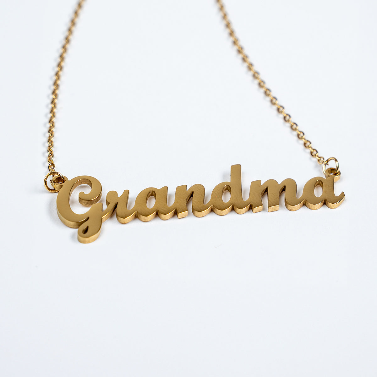 Gold 'Grandma' necklace on a white background