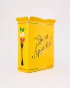 Yellow tin box with 'Buon Appetito!' text and pasta symbols on a white background
