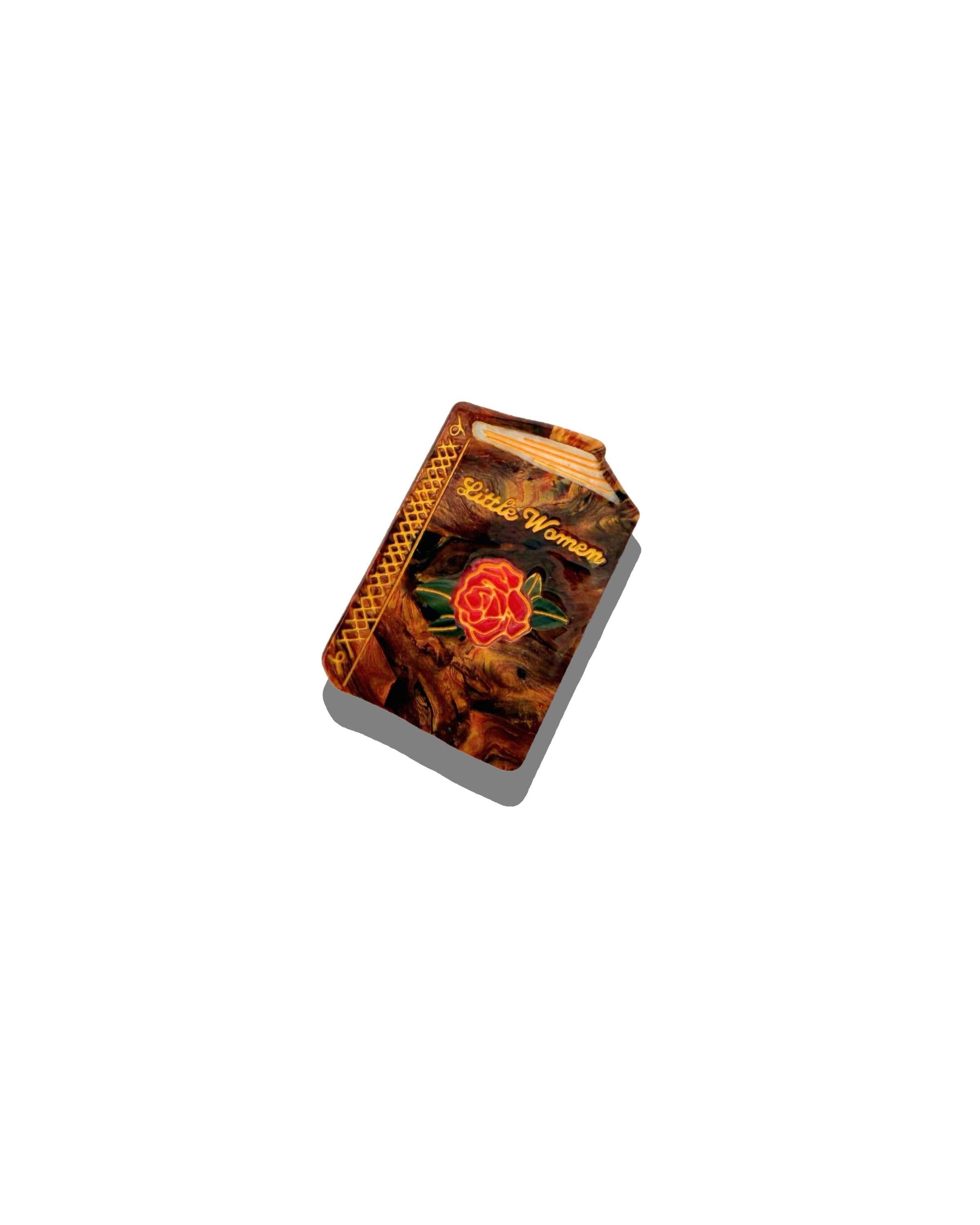 Small rectangular hair clip with decorative Little Women design on a white background
