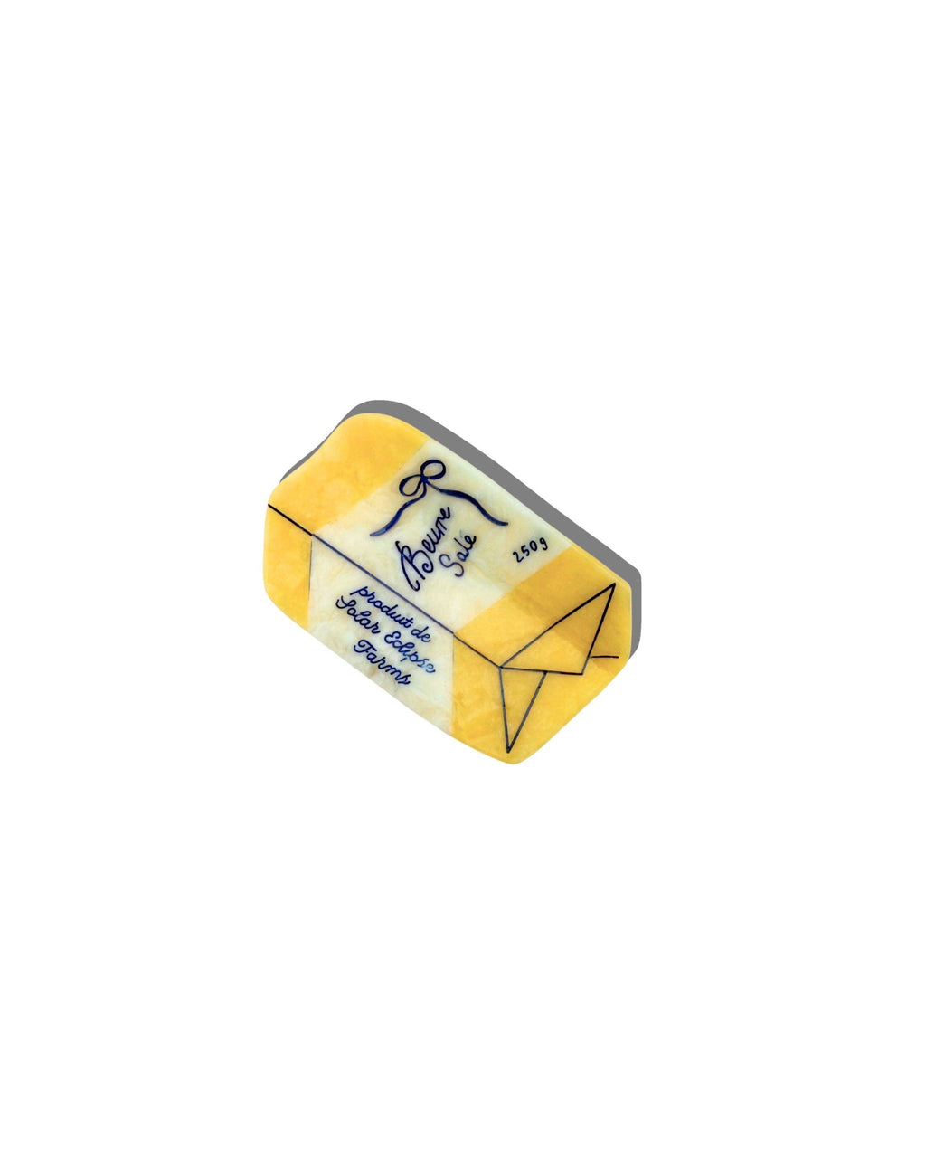 Yellow butter claw clip with blue details on a white back ground