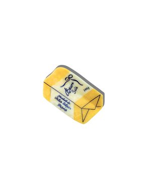 Yellow butter claw clip with blue details on a white back ground