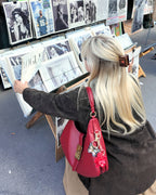 Woman looking at art in a store wearing a Little Women hair clip