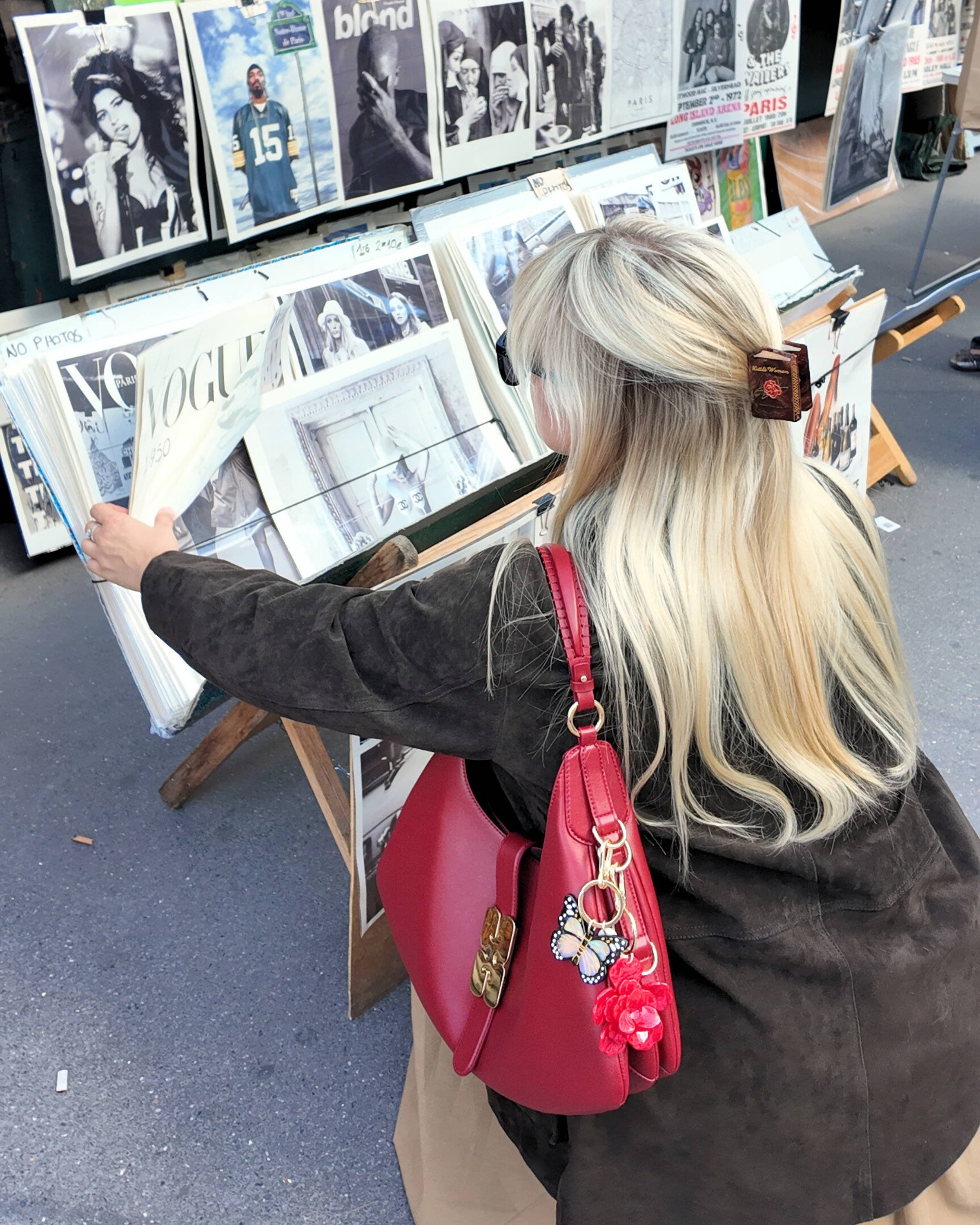 Woman looking at art in a store wearing a Little Women hair clip