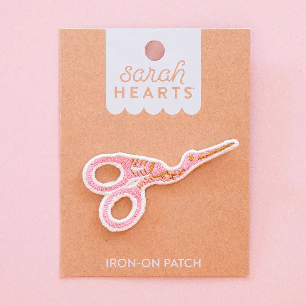 Sarah Hearts Iron-on scissors patch with a pink background