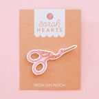 Sarah Hearts Iron-on scissors patch with a pink background