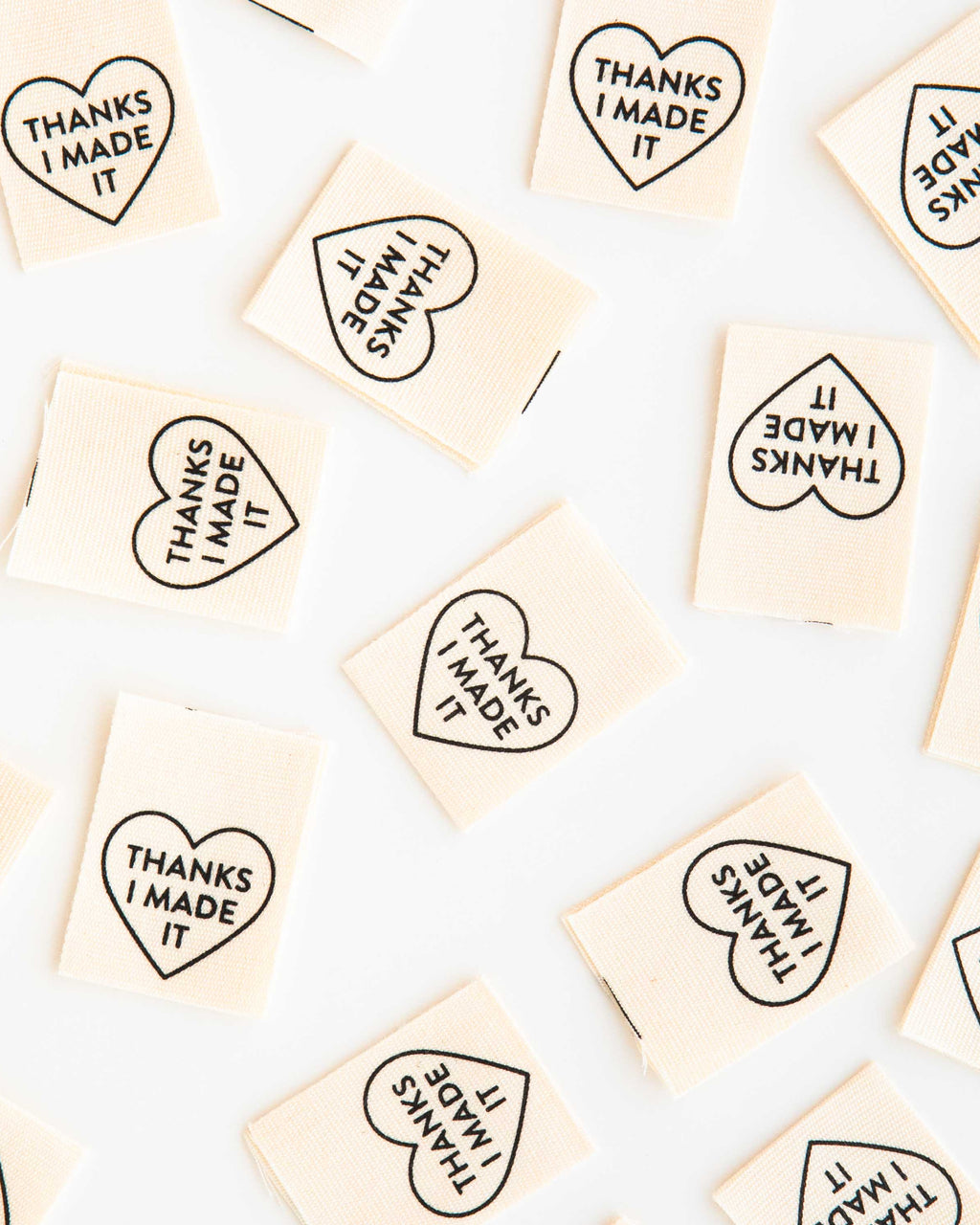Small square tiles with heart-shaped text on a white background