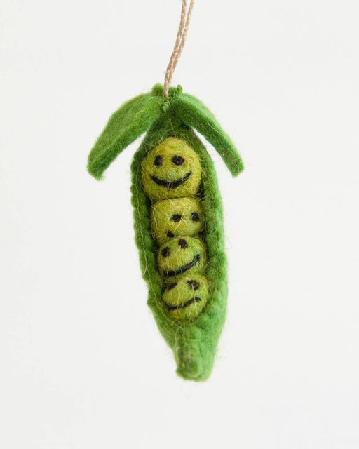 Felted green pea pod with a smiling yellow caterpillar inside on a white background