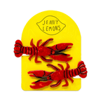 Two red lobster-shaped Hair pins on a yellow 'Jenny Lemons' card.