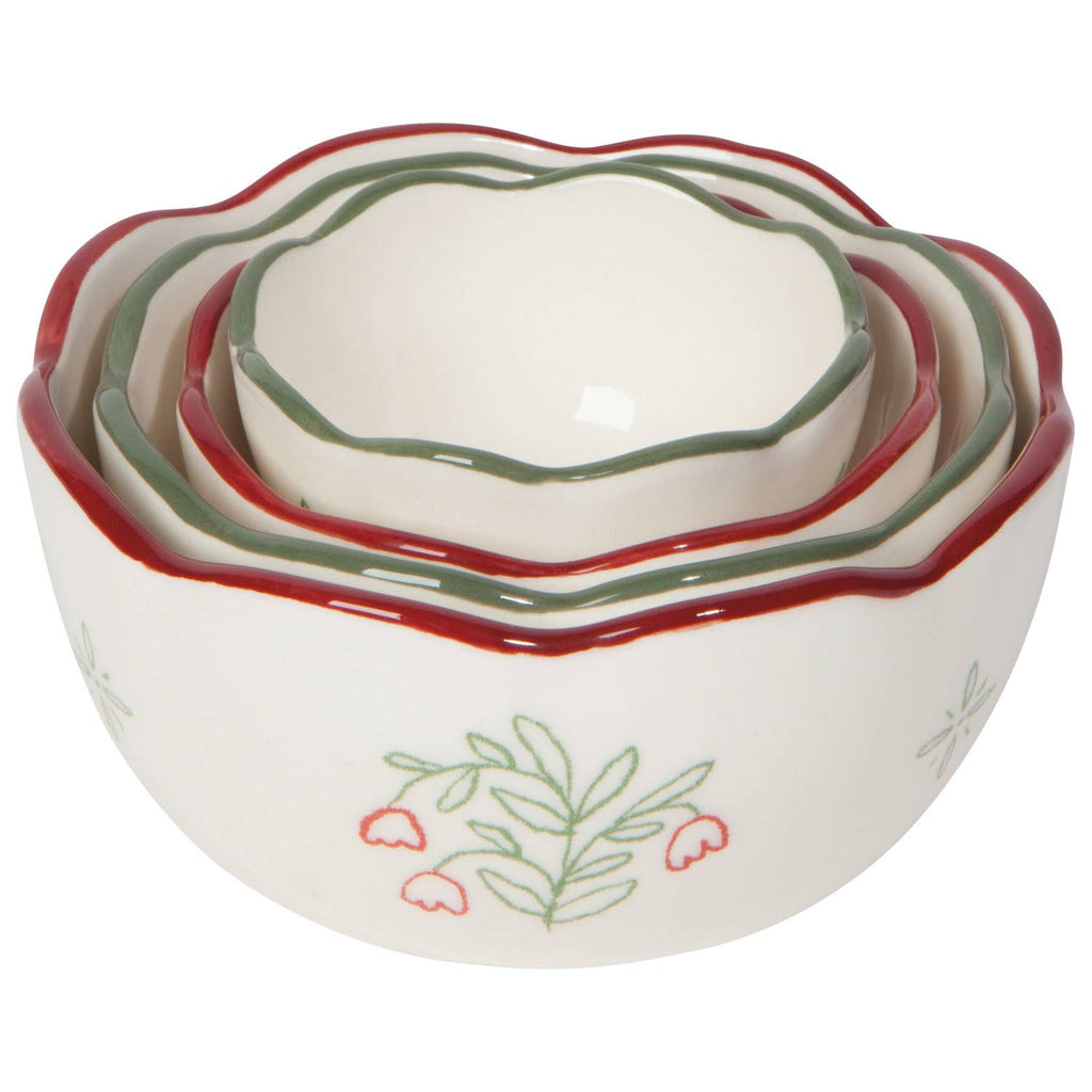 Set of four ceramic nesting bowls with floral design on a white background