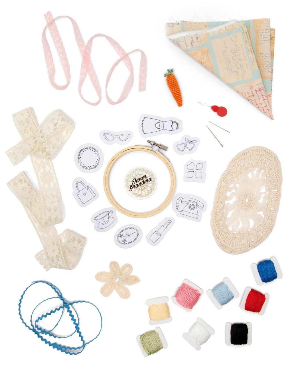 Collection of embroidery and craft supplies including ribbons, thread, and patterns on a white background.