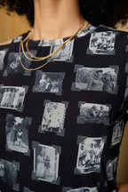 Person wearing black and gray mesh fabric with printed black and white images of grandmas, people and objects.