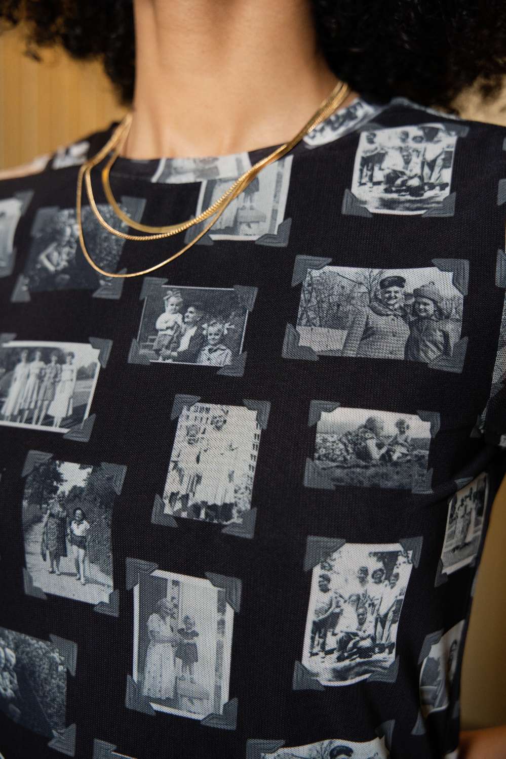 Person wearing black and gray mesh fabric with printed black and white images of grandmas, people and objects.