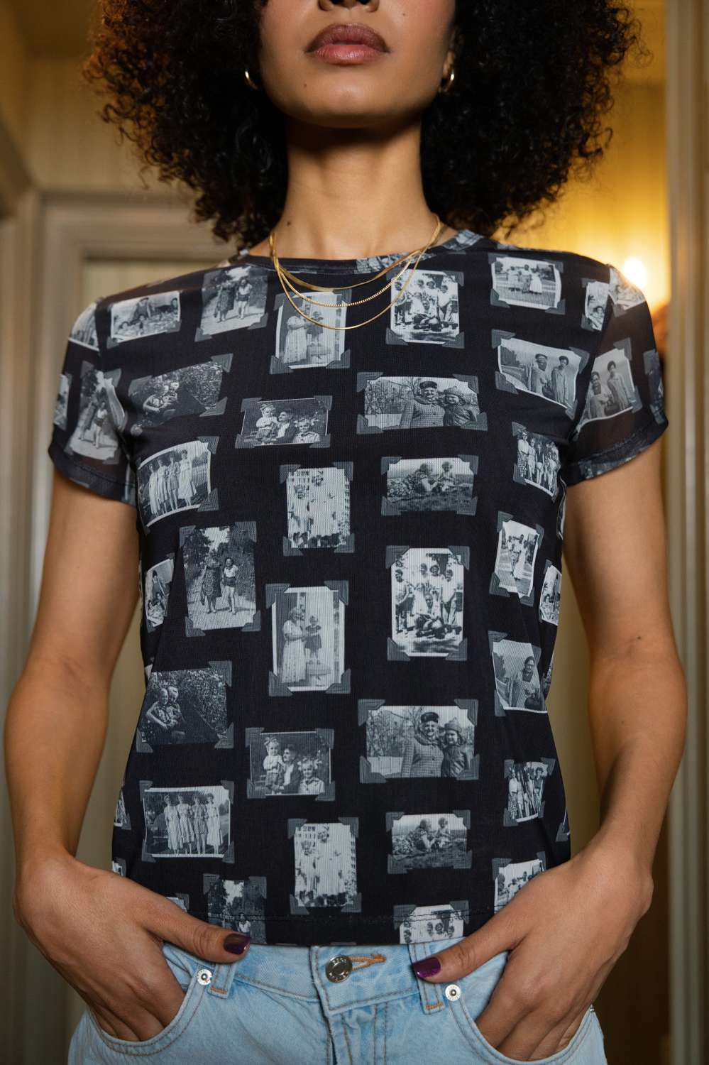 Person wearing black and gray mesh fabric top with printed black and white images of grandmas, people and objects.