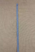 Blue measuring tape ribbon on a beige fabric background