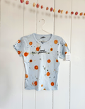 Short-sleeve light blue cropped baby tee shirt with floral pattern naturally dyed by flowers with "Inner Grandma" text