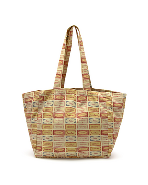 Tote bag with patterned fabric of vegetable labels of pickles, peppers, tomatoes, asparagus and onions on a white background