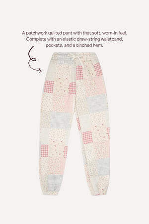 Patchwork quilted lounge pants with a soft, worn-in feel, featuring a mix of pink, red, blue, and beige gingham, floral, and checkered fabric squares. The pants are shown with a white elastic drawstring waistband and side pockets, set against a light beige background with descriptive text at the top.