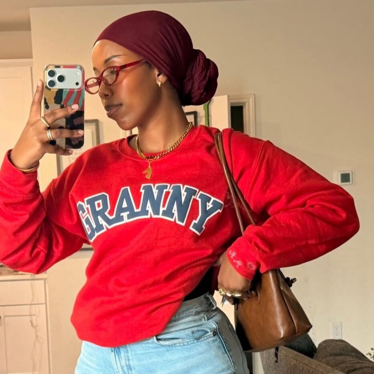 women taking a selfie in the red sweatshirt that says "GRANNY"