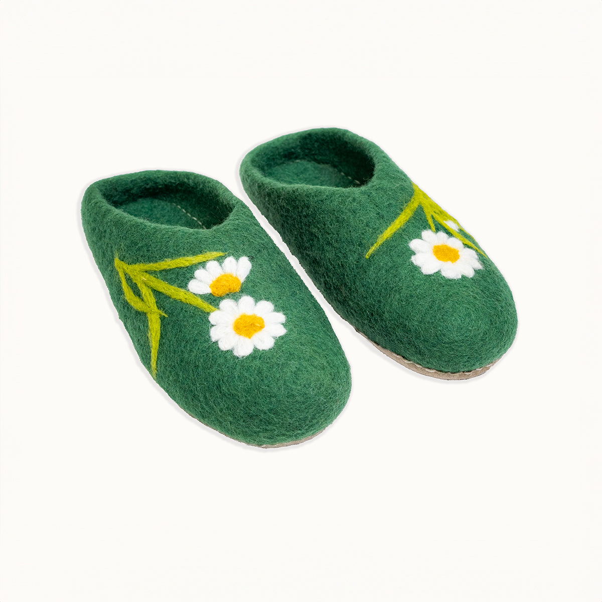 Green slippers with white daisy flowers on a white background