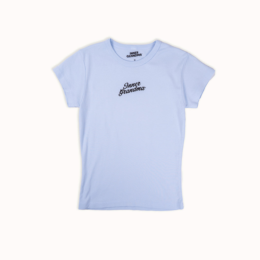 Light blue cropped baby t-shirt with 'Inner Grandma' text on a white background