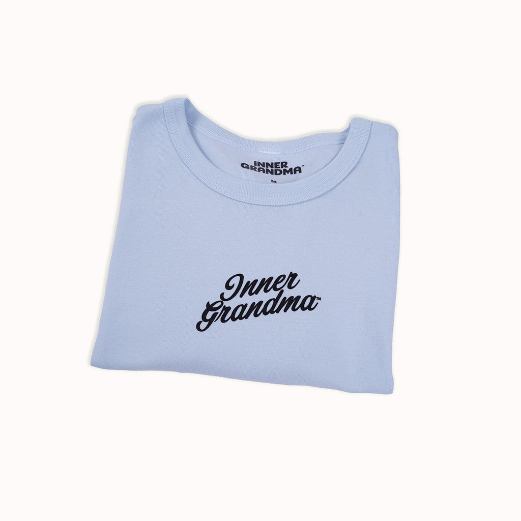 Light blue cropped baby t-shirt with 'Inner Grandma' text on a white background