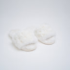 White fluffy slippers on a light gray background