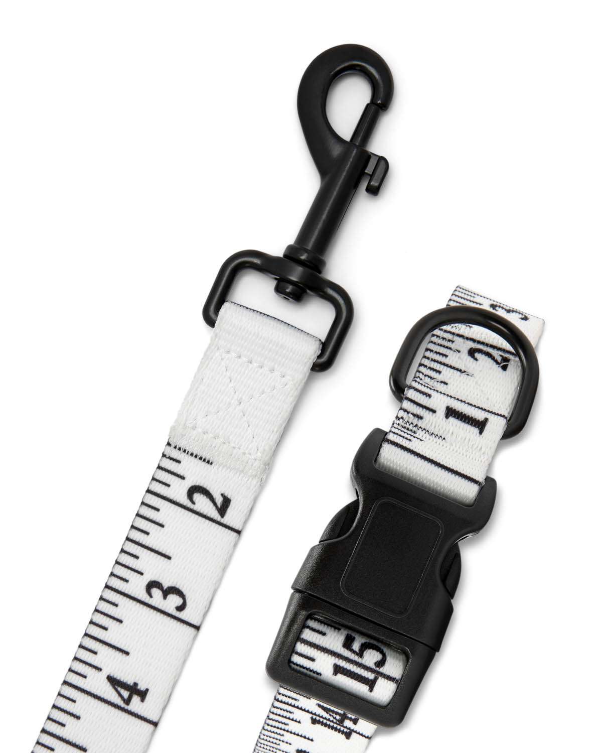 Measurement tape leash with black clip on a white background