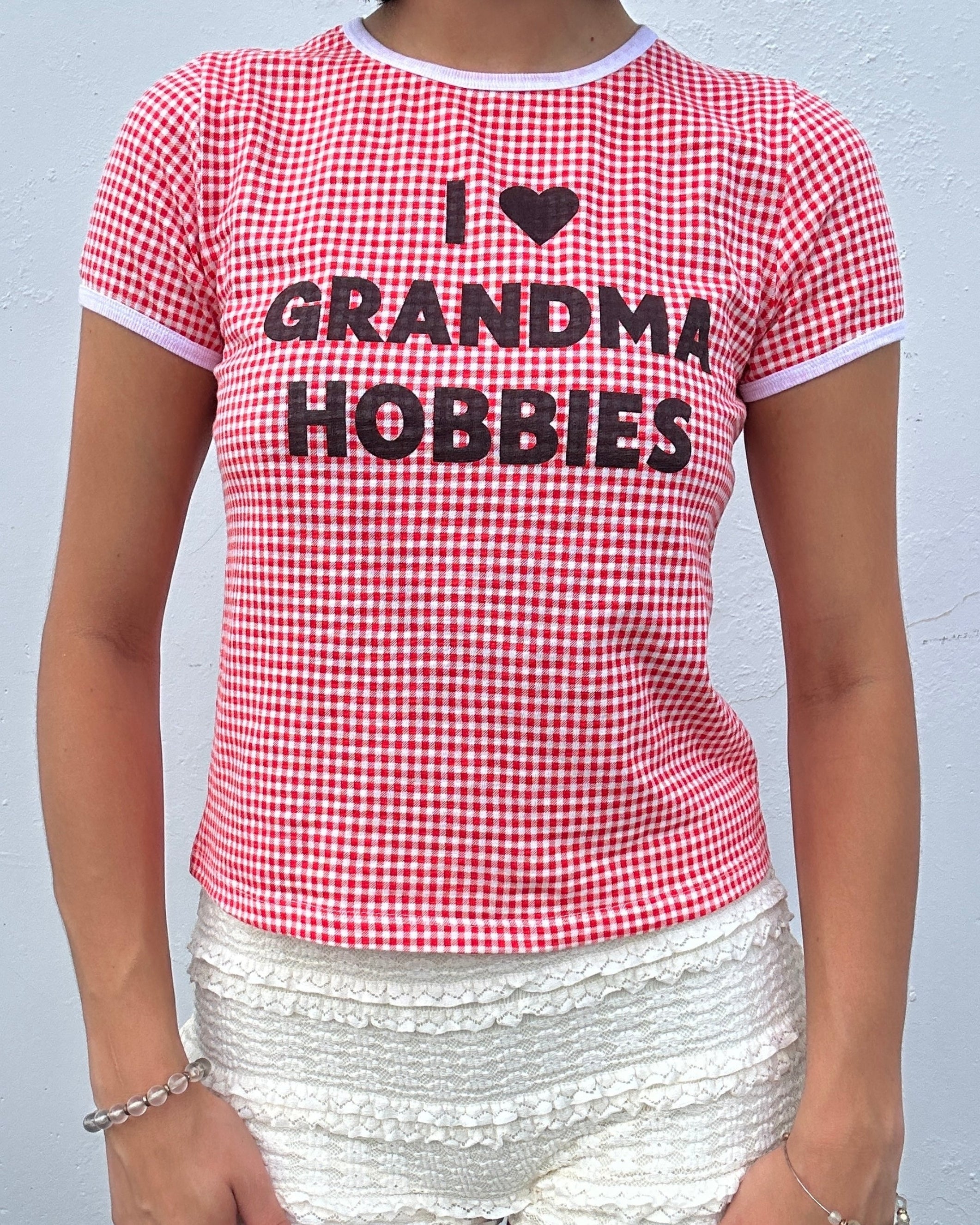 Person wearing a red and white checkered shirt with 'I ❤️ Grandma Hobbies' text.