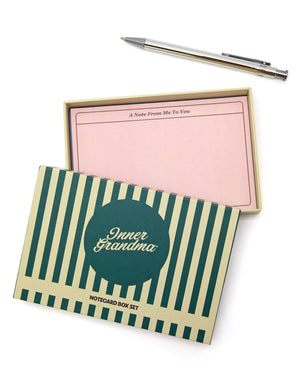 Notecard box set with striped design and pink interior on a white background