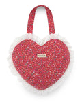 Pink heart-shaped bag with quilted floral pattern and eyelet ruffled edge