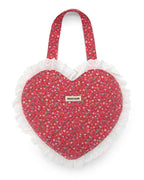 Pink heart-shaped bag with quilted floral pattern and eyelet ruffled edge