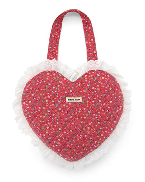 Pink heart-shaped bag with quilted floral pattern and eyelet ruffled edge