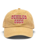 Yellow baseball cap with 'Deviled Eggs' embroidered in red on a white background