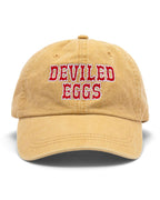 Yellow baseball cap with 'Deviled Eggs' embroidered in red on a white background