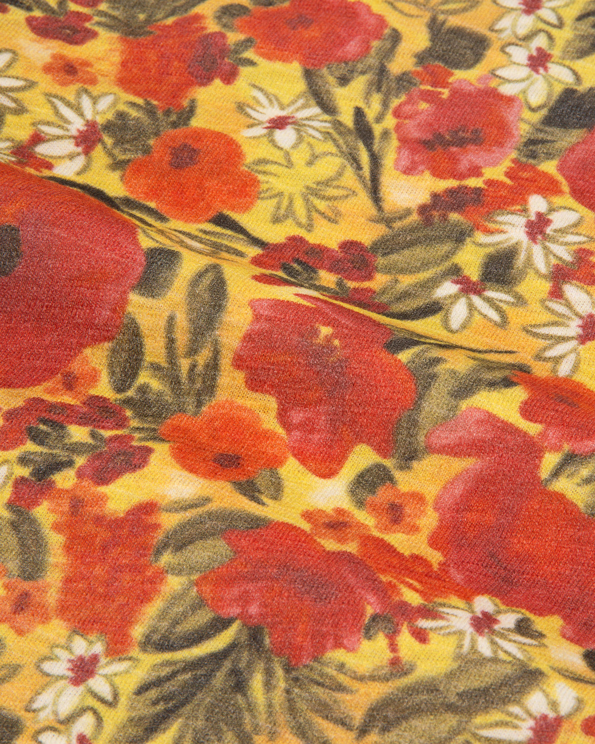 A close-up of a vintage floral fabric print featuring large red poppies, white daisies, and green leaves on a warm yellow background.